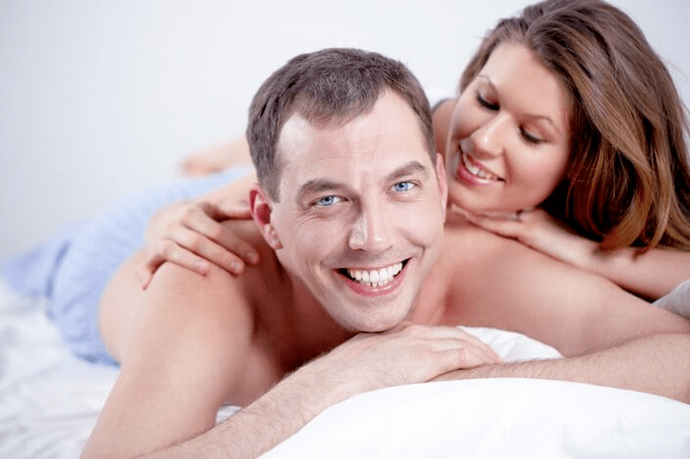 Men and women in bed